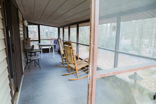 unfurnished sunroom featuring wood ceiling