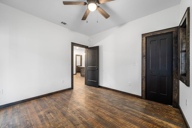 unfurnished bedroom with ceiling fan and dark hardwood / wood-style floors