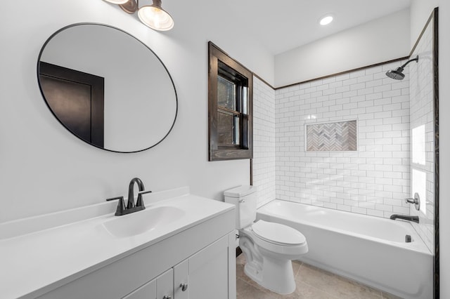 full bathroom with tile patterned flooring, vanity, tiled shower / bath combo, and toilet