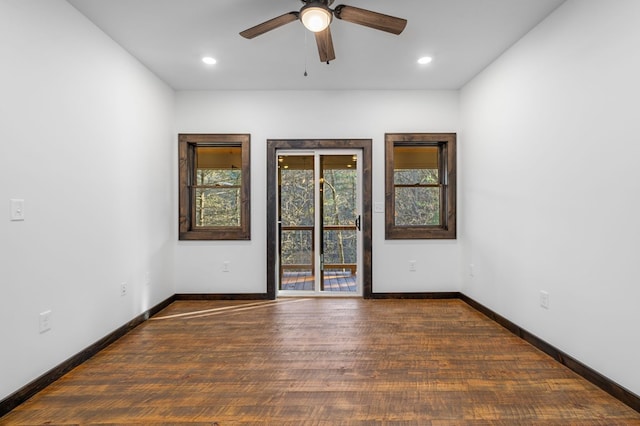 spare room with ceiling fan and dark hardwood / wood-style floors