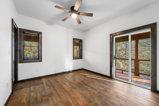 unfurnished room with plenty of natural light, ceiling fan, and dark hardwood / wood-style flooring