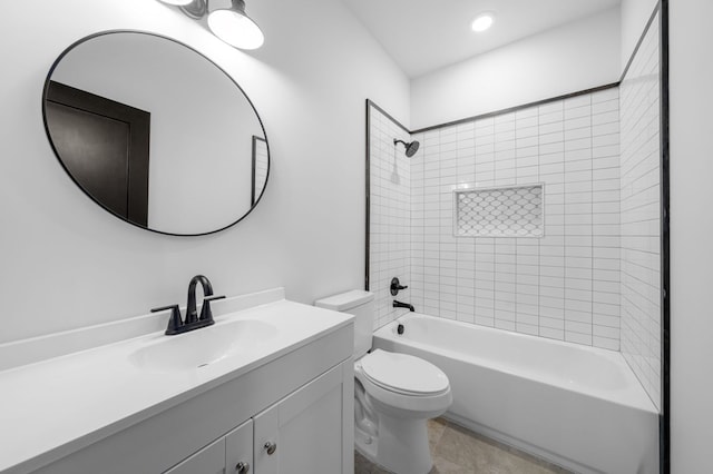 full bathroom with vanity, tiled shower / bath combo, toilet, and tile patterned flooring