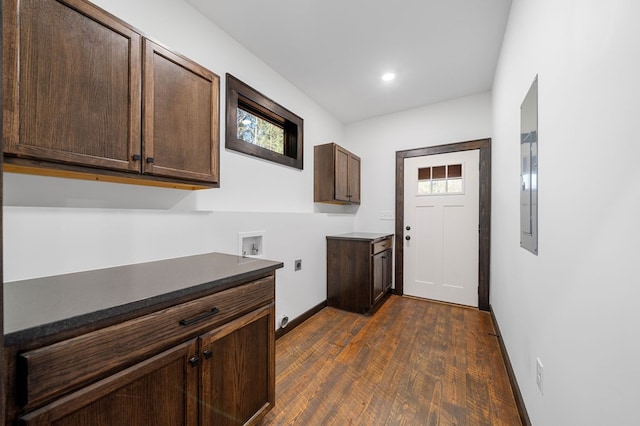 laundry room with electric dryer hookup, cabinets, dark wood-type flooring, and hookup for a washing machine