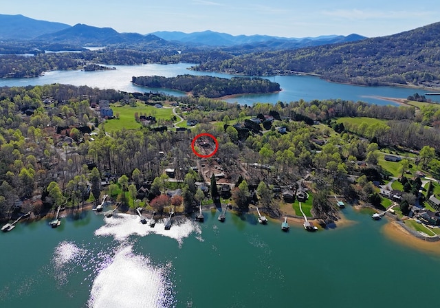 drone / aerial view featuring a water and mountain view