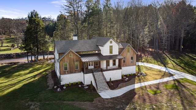 view of front of home featuring covered porch and a front lawn