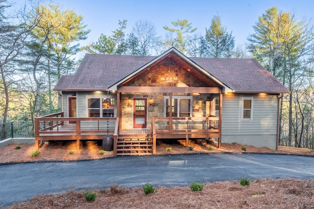 rustic home with roof with shingles