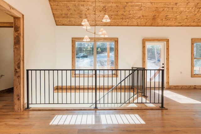 interior space featuring baseboards, lofted ceiling, and wood finished floors