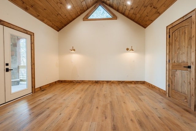 spare room with a healthy amount of sunlight, wooden ceiling, and light wood finished floors