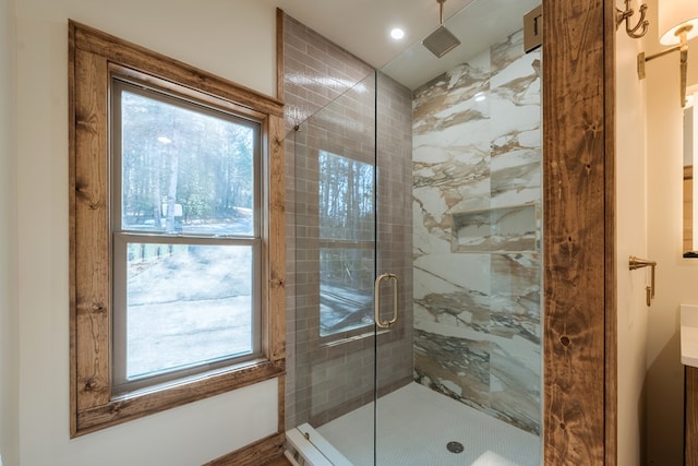 bathroom with a stall shower and vanity