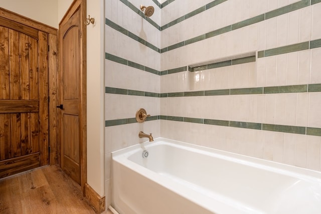 full bath featuring a garden tub and wood finished floors