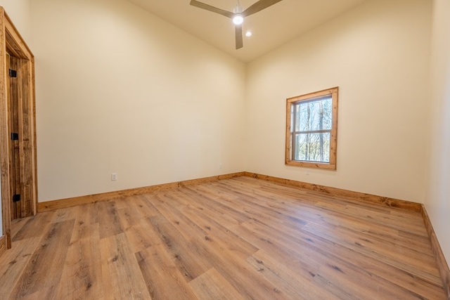 unfurnished room with baseboards, light wood-style floors, and a ceiling fan