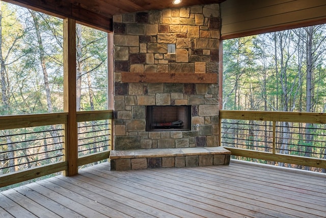 deck featuring an outdoor stone fireplace