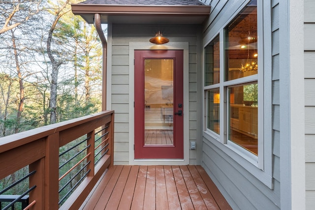 property entrance with a shingled roof