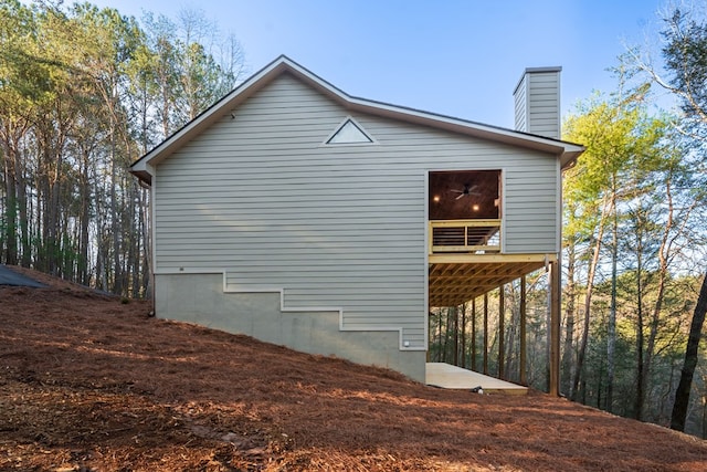 view of side of home with a chimney