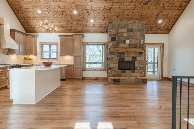 kitchen featuring decorative backsplash, custom exhaust hood, light wood-style flooring, and light countertops