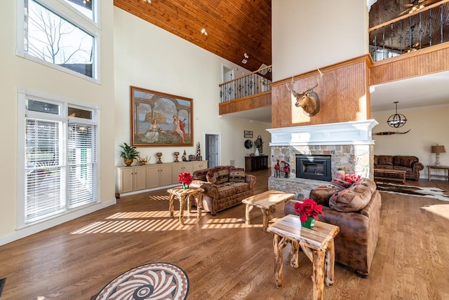 33 Tj Mote Rd, Dahlonega, GA 30533 - living area featuring high vaulted ceiling, healthy amount of natural light, a stone fireplace, wood finished floors, and wood ceiling