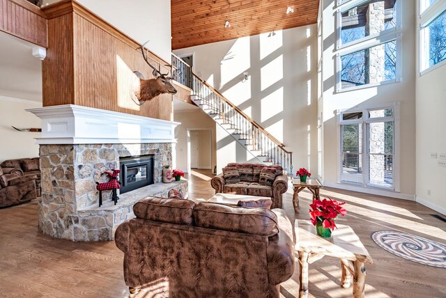 33 Tj Mote Rd, Dahlonega, GA 30533 - living area with a towering ceiling, stairs, wood finished floors, a fireplace, and crown molding