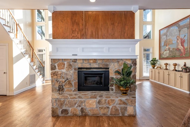 33 Tj Mote Rd, Dahlonega, GA 30533 - living area featuring baseboards, a fireplace, stairway, wood finished floors, and a high ceiling