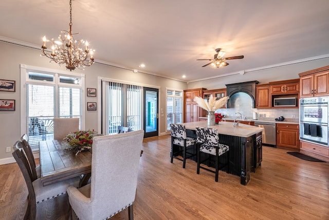 33 Tj Mote Rd, Dahlonega, GA 30533 - dining area featuring a chandelier, crown molding, light wood finished floors, healthy amount of natural light, and ceiling fan