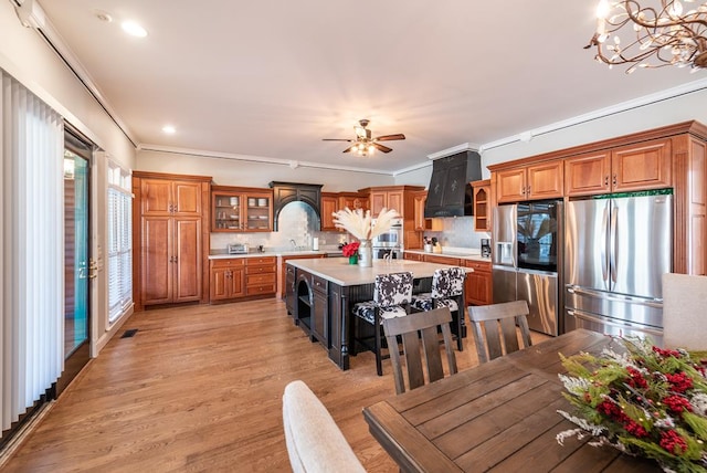 33 Tj Mote Rd, Dahlonega, GA 30533 - kitchen with freestanding refrigerator, premium range hood, light countertops, brown cabinets, and crown molding