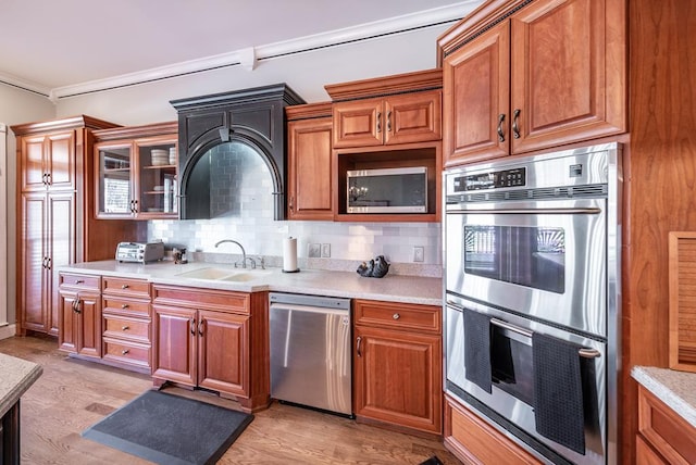 33 Tj Mote Rd, Dahlonega, GA 30533 - kitchen featuring stainless steel appliances, a sink, brown cabinetry, light countertops, and ornamental molding