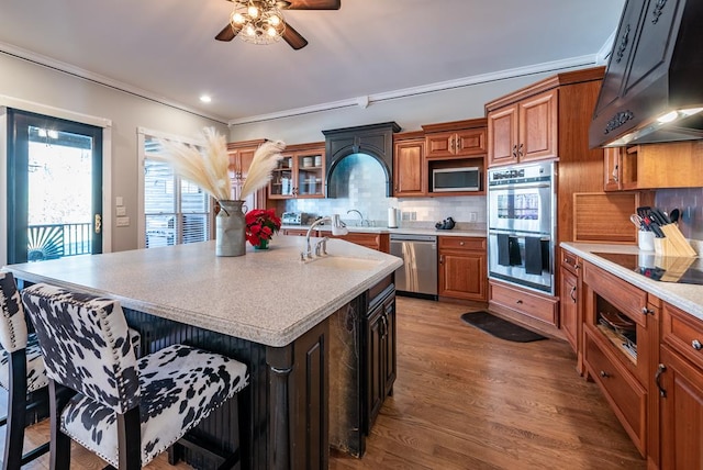 33 Tj Mote Rd, Dahlonega, GA 30533 - kitchen with stainless steel appliances, wall chimney exhaust hood, a ceiling fan, a sink, and brown cabinets