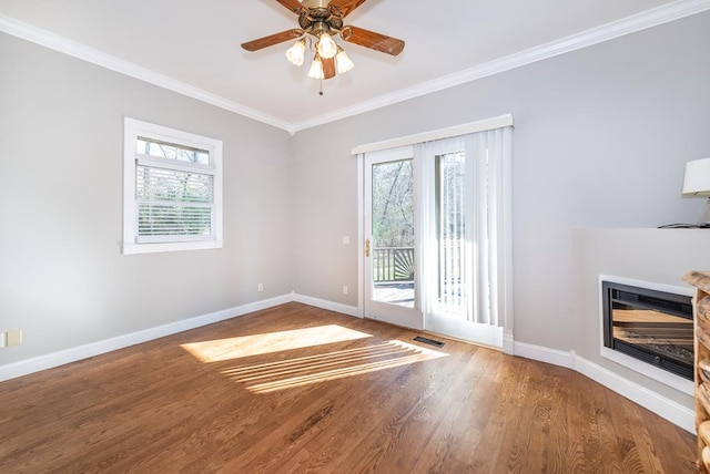 33 Tj Mote Rd, Dahlonega, GA 30533 - unfurnished living room featuring ornamental molding, baseboards, wood finished floors, a glass covered fireplace, and a ceiling fan