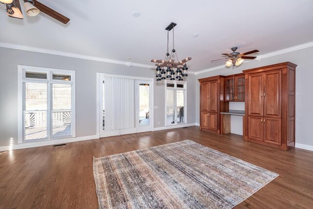 33 Tj Mote Rd, Dahlonega, GA 30533 - unfurnished living room featuring a ceiling fan, dark wood-type flooring, crown molding, baseboards, and a chandelier