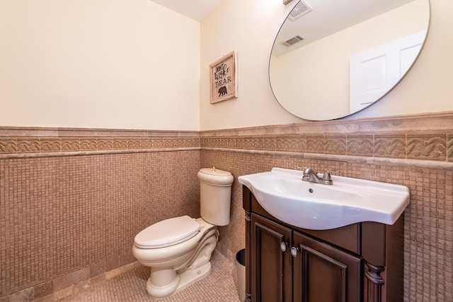 33 Tj Mote Rd, Dahlonega, GA 30533 - half bathroom featuring a wainscoted wall, vanity, tile walls, toilet, and tile patterned floors