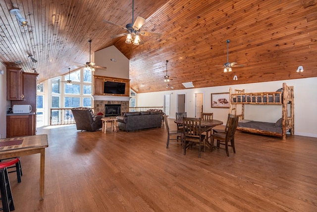 33 Tj Mote Rd, Dahlonega, GA 30533 - dining space featuring a ceiling fan, a glass covered fireplace, high vaulted ceiling, wood finished floors, and wooden ceiling
