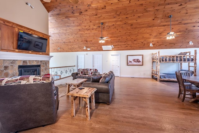33 Tj Mote Rd, Dahlonega, GA 30533 - living area featuring ceiling fan, high vaulted ceiling, a stone fireplace, wood finished floors, and wooden ceiling