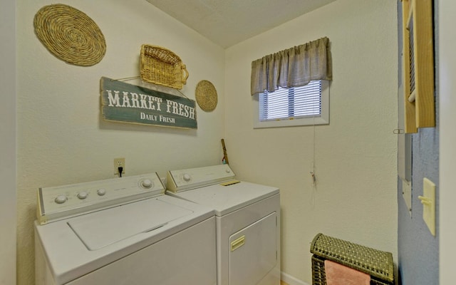 laundry room featuring a textured ceiling and separate washer and dryer