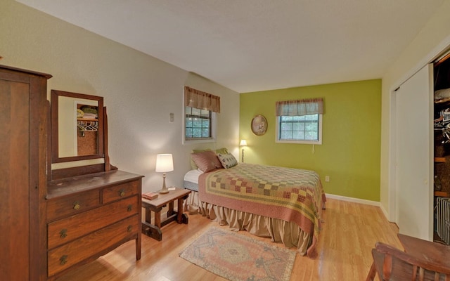 bedroom featuring light hardwood / wood-style floors and a closet