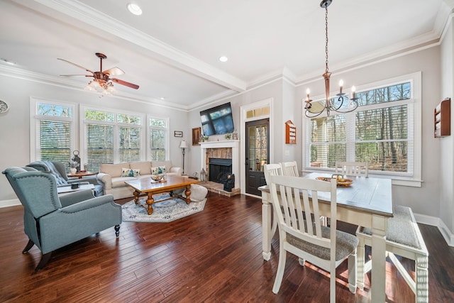 dining space featuring plenty of natural light, dark hardwood / wood-style floors, ornamental molding, and ceiling fan with notable chandelier