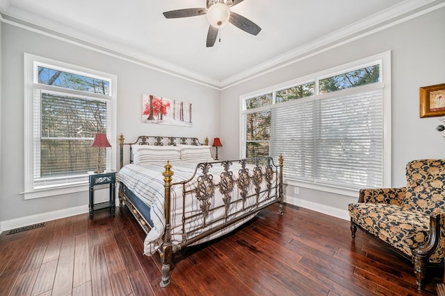 bedroom with dark hardwood / wood-style floors, ceiling fan, and crown molding