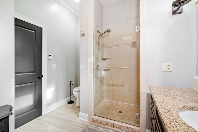 bathroom with vanity, toilet, walk in shower, and ornamental molding