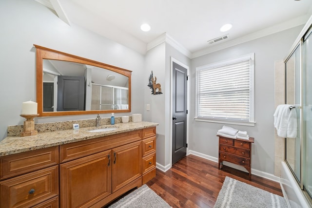 bathroom with hardwood / wood-style flooring, vanity, and crown molding