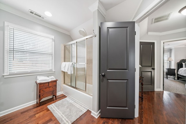 bathroom featuring combined bath / shower with glass door, hardwood / wood-style floors, and plenty of natural light