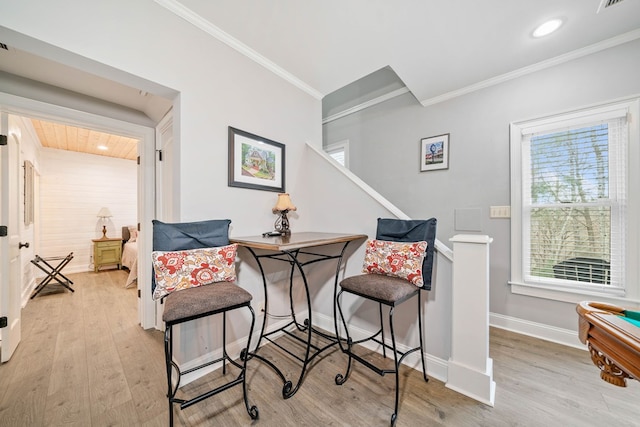 sitting room featuring crown molding and light hardwood / wood-style flooring