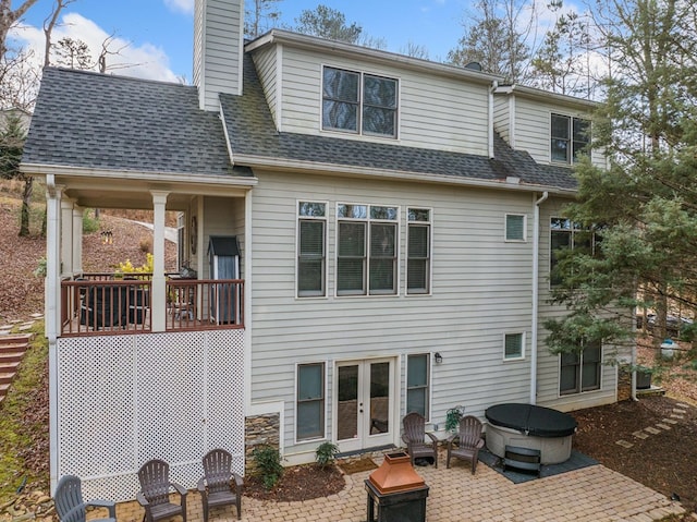 rear view of property featuring a patio area and french doors