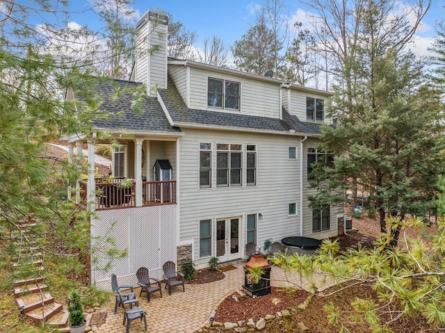 rear view of property with french doors and a patio area