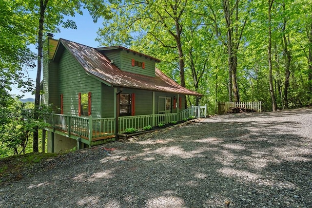 127 Berry Reister Dr, Blairsville, GA 30512 - view of property exterior featuring a porch, a chimney, metal roof, and driveway