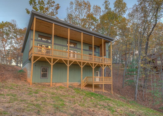 back of property featuring a balcony