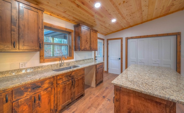 kitchen featuring light hardwood / wood-style floors, light stone counters, wood ceiling, vaulted ceiling, and sink