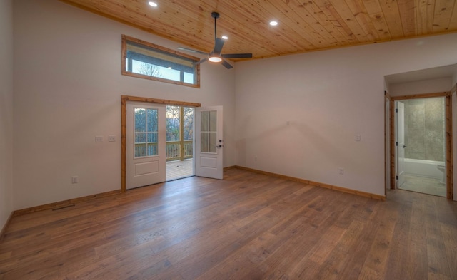 unfurnished room with hardwood / wood-style floors, a wealth of natural light, ceiling fan, and wooden ceiling