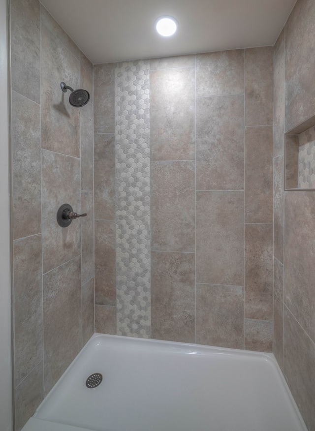 bathroom with tiled shower