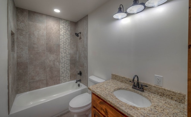 full bathroom featuring toilet, vanity, and tiled shower / bath