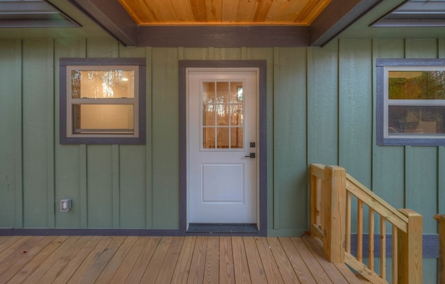 view of exterior entry featuring a wooden deck