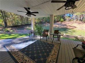 wooden deck featuring ceiling fan