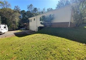 view of side of property with a lawn